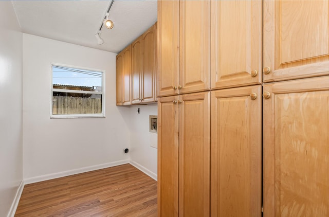 laundry area featuring washer hookup, cabinets, electric dryer hookup, and hardwood / wood-style flooring