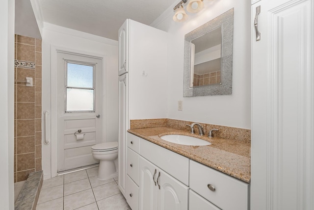 bathroom with toilet, tile patterned flooring, and vanity