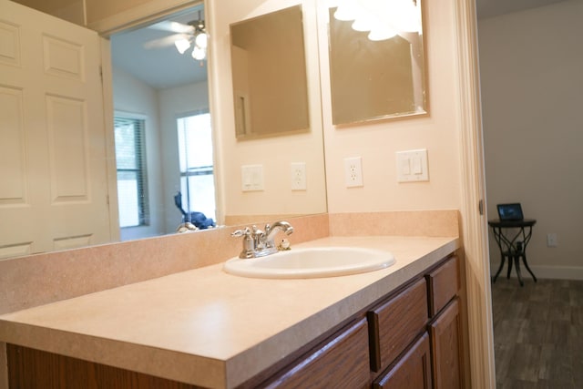 bathroom with vanity, hardwood / wood-style flooring, ceiling fan, and lofted ceiling