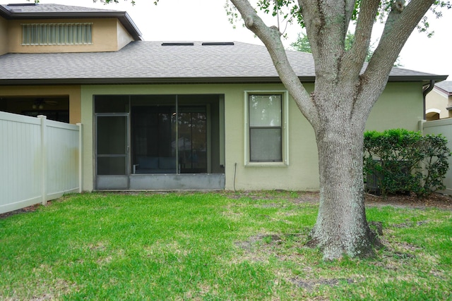 rear view of house featuring a yard