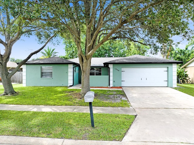 ranch-style home with a garage and a front lawn