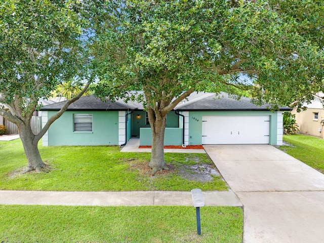 view of front of home featuring a garage and a front yard