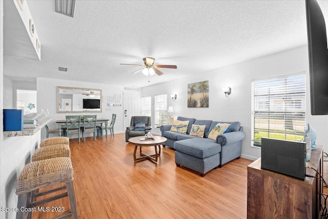 202 Monroe Ave, Cape Canaveral, FL 32920 - living room featuring ceiling fan, a textured ceiling, and light wood-type flooring