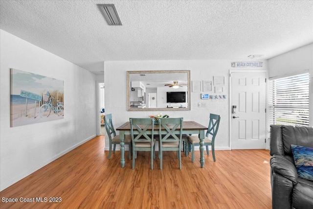 202 Monroe Ave, Cape Canaveral, FL 32920 - dining area featuring hardwood / wood-style floors and a textured ceiling
