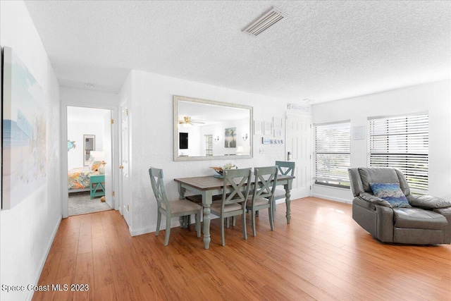 202 Monroe Ave, Cape Canaveral, FL 32920 - dining space featuring hardwood / wood-style flooring and a textured ceiling
