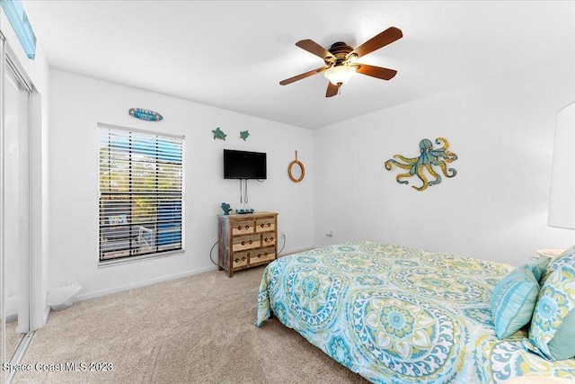 202 Monroe Ave, Cape Canaveral, FL 32920 - bedroom featuring ceiling fan, light colored carpet, and a closet