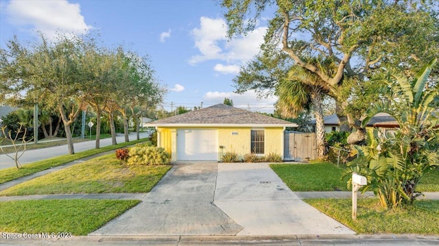 202 Monroe Ave, Cape Canaveral, FL 32920 - view of front of house with a garage and a front lawn