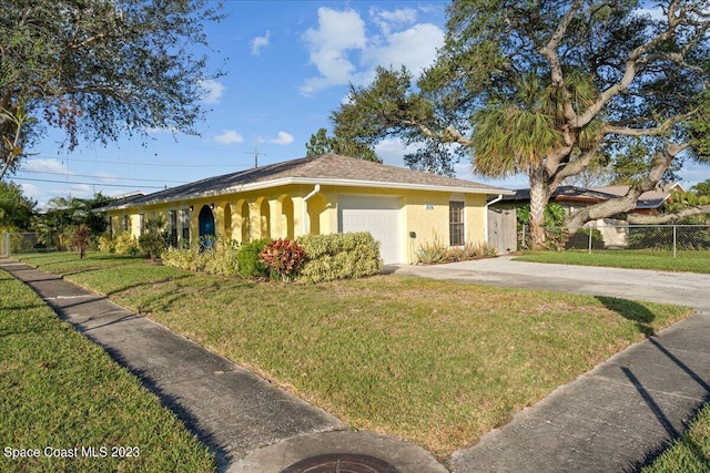 202 Monroe Ave, Cape Canaveral, FL 32920 - view of front of house with a garage and a front yard