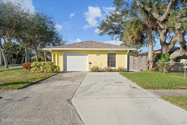 202 Monroe Ave, Cape Canaveral, FL 32920 - single story home featuring a garage and a front lawn