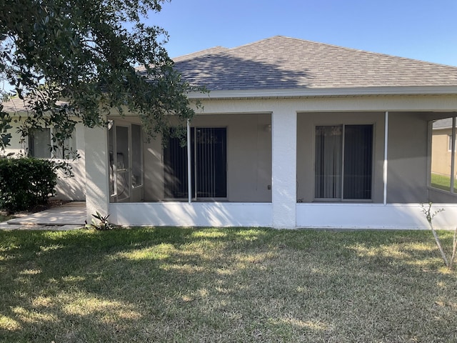 rear view of property with a lawn