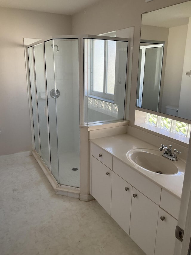 bathroom featuring an enclosed shower and a healthy amount of sunlight