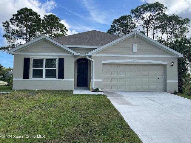 single story home with a garage and a front lawn