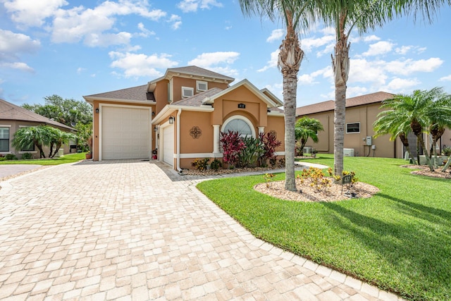 view of front of property featuring a garage and a front lawn