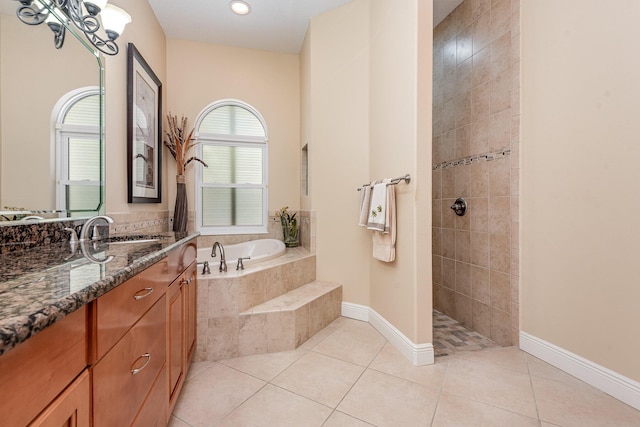 bathroom featuring sink, shower with separate bathtub, and tile patterned flooring