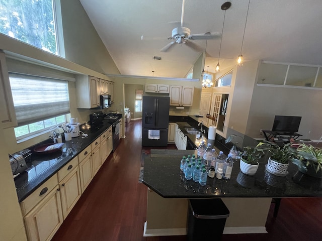 kitchen featuring a healthy amount of sunlight, black appliances, pendant lighting, high vaulted ceiling, and dark hardwood / wood-style floors