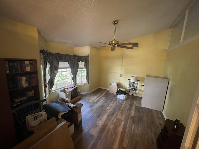 sitting room featuring a textured ceiling, ceiling fan, and dark wood-type flooring