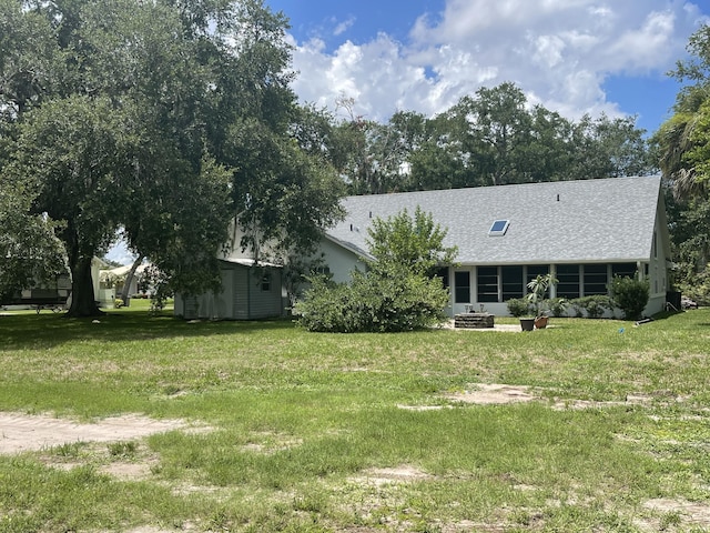 exterior space featuring a shed and a front yard