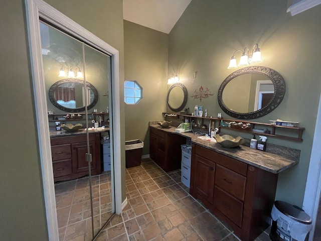 bathroom with vanity and lofted ceiling