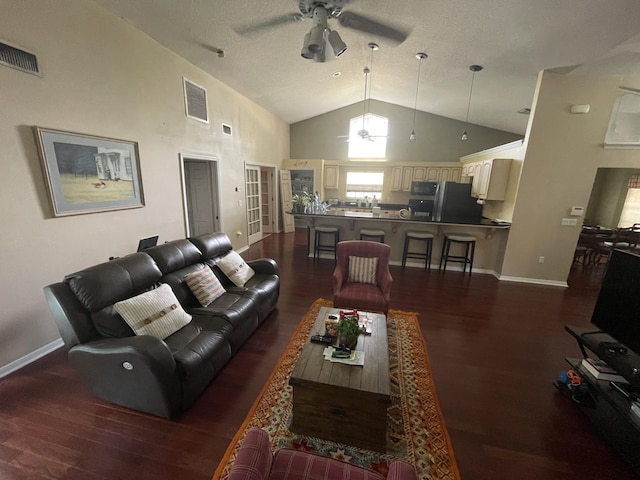 living room featuring a textured ceiling, dark hardwood / wood-style floors, high vaulted ceiling, and ceiling fan