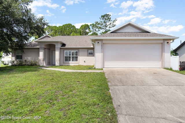 ranch-style house featuring a garage and a front lawn