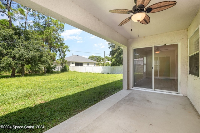 view of yard with ceiling fan and a patio