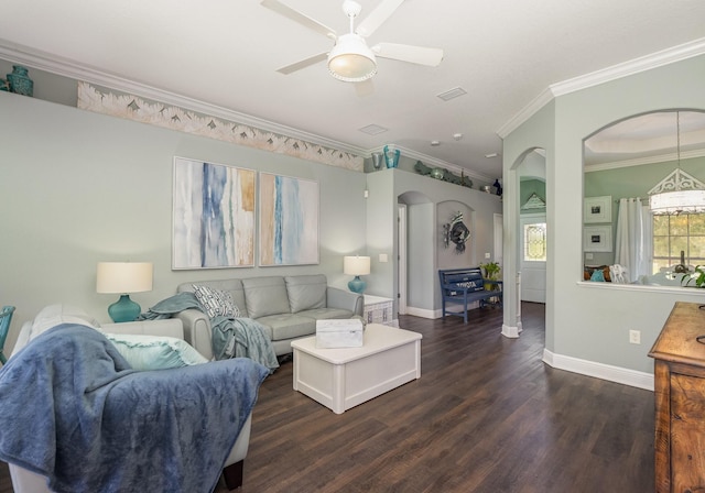 living room with ornamental molding, ceiling fan, and dark hardwood / wood-style floors