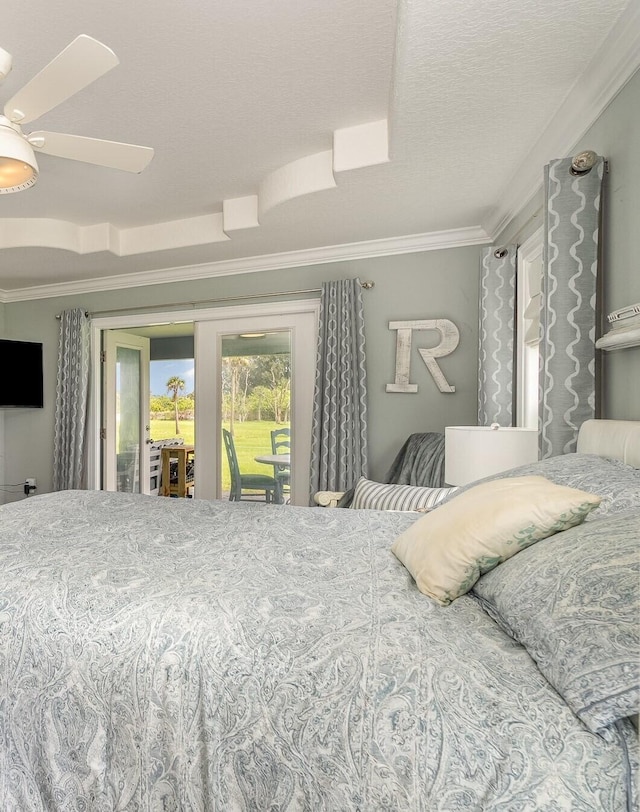 bedroom featuring access to outside, ceiling fan, a raised ceiling, crown molding, and a textured ceiling