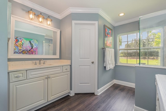 bathroom with ornamental molding, hardwood / wood-style floors, and vanity