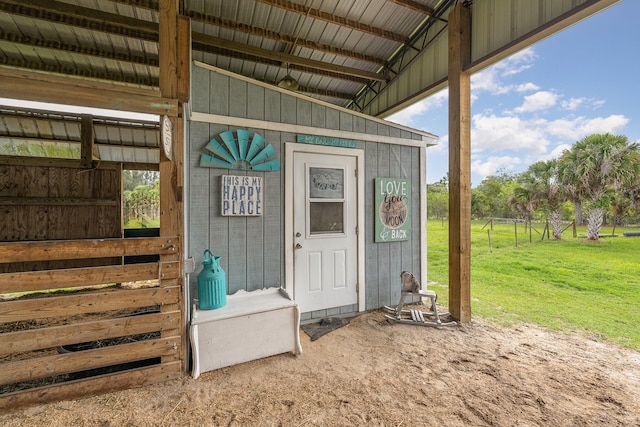 entrance to property featuring a lawn