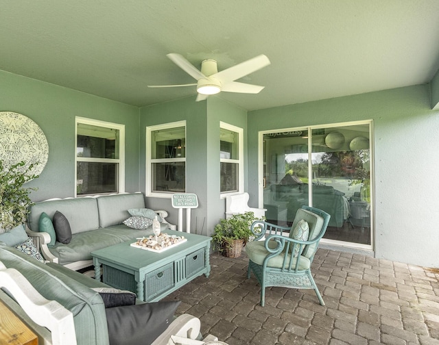 sunroom with ceiling fan