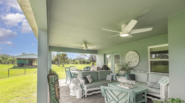 view of patio / terrace with an outdoor living space with a fire pit, ceiling fan, and a gazebo