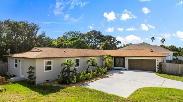 ranch-style house with a front yard and a garage