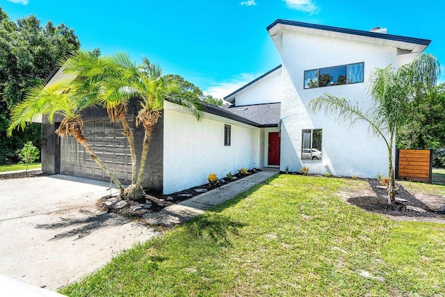 view of front of property with a garage and a front lawn