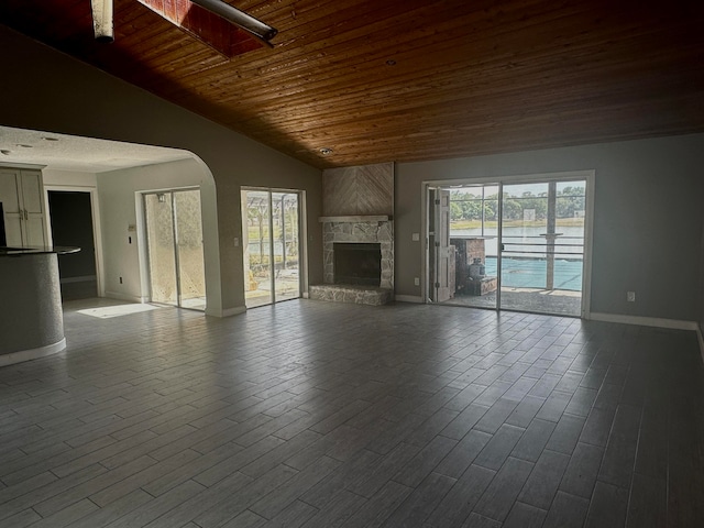 unfurnished living room with dark hardwood / wood-style floors, a fireplace, lofted ceiling, and wood ceiling