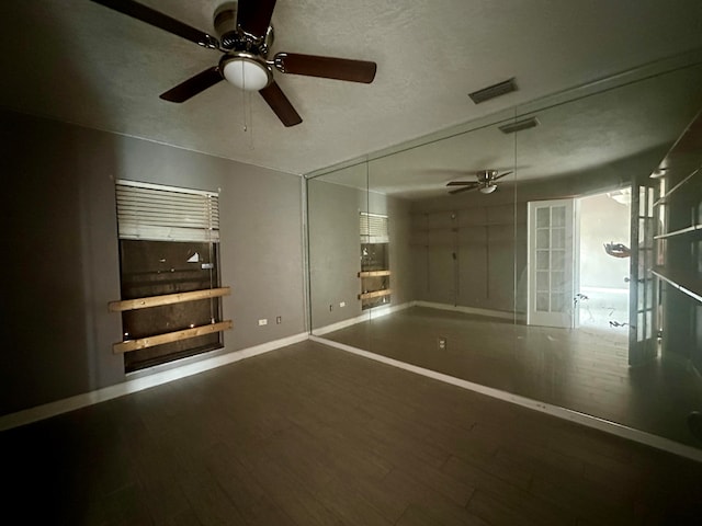 unfurnished bedroom with hardwood / wood-style flooring and a textured ceiling