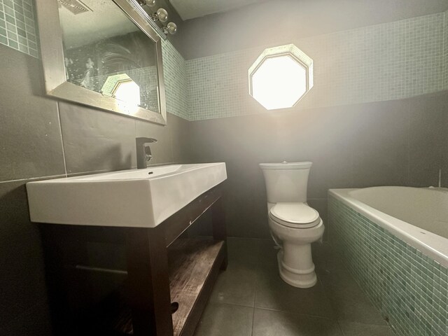 368 Fairgreen Pl, Casselberry, FL 32707 - bathroom with visible vents, tiled bath, toilet, vanity, and tile patterned flooring