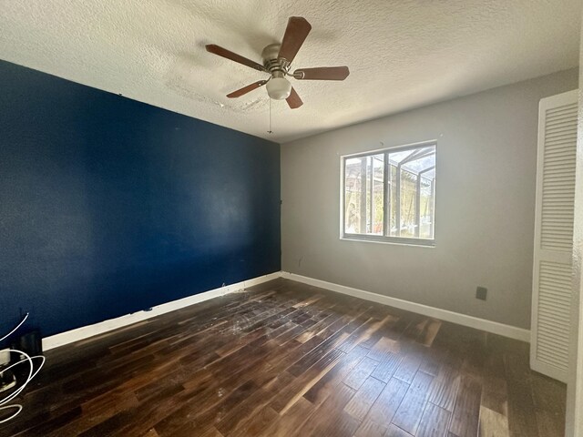 empty room featuring a textured ceiling, ceiling fan, and hardwood / wood-style floors