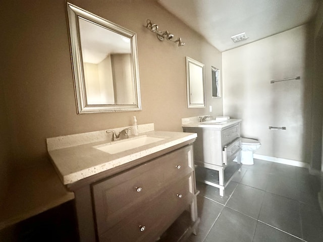 bathroom with dual bowl vanity, tile flooring, and toilet