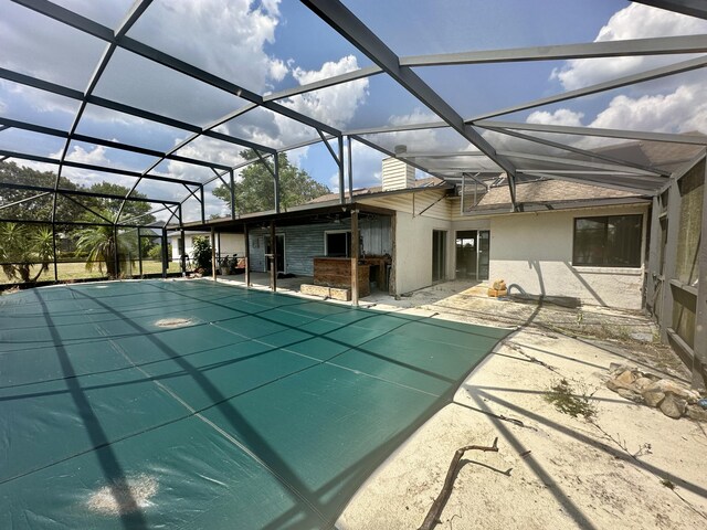 view of swimming pool featuring a lanai and a patio area