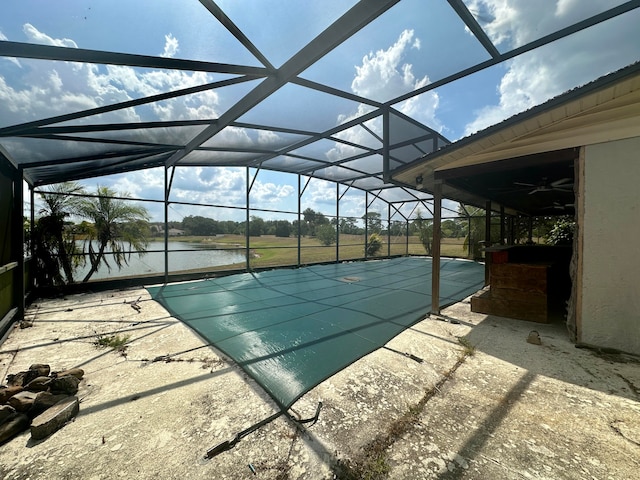 view of swimming pool with a patio, a lanai, and a water view