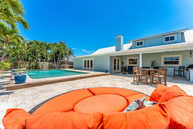 view of pool with french doors, a patio area, and an outdoor hangout area