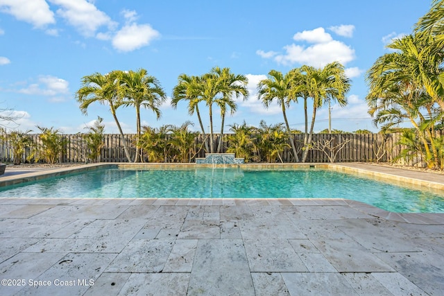 view of swimming pool featuring a fenced backyard, a fenced in pool, and a patio