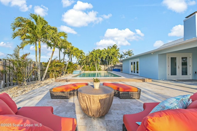 view of swimming pool featuring a patio, french doors, a fenced backyard, and a fenced in pool