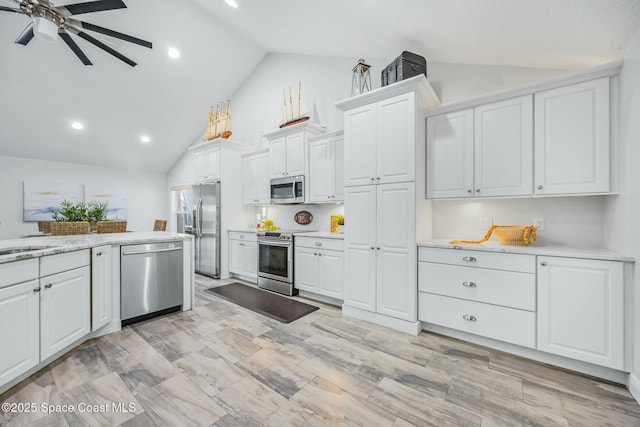 kitchen featuring stainless steel appliances, a sink, a ceiling fan, and white cabinets