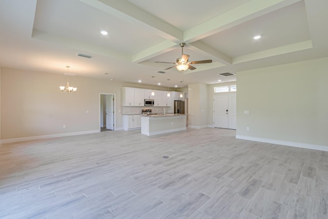 unfurnished living room with sink, beamed ceiling, light hardwood / wood-style flooring, and ceiling fan with notable chandelier