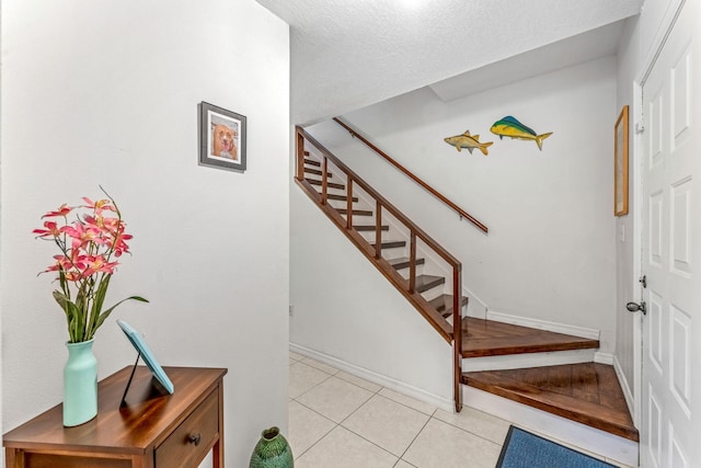 staircase featuring tile patterned floors