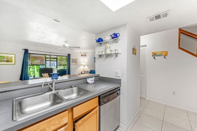 kitchen with ceiling fan, sink, stainless steel dishwasher, light brown cabinetry, and light tile patterned floors