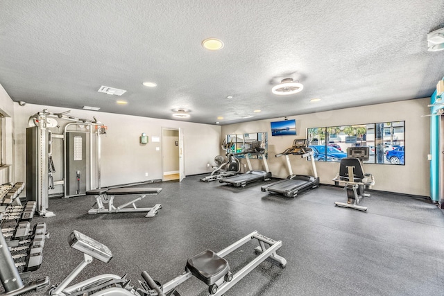 workout area featuring a textured ceiling