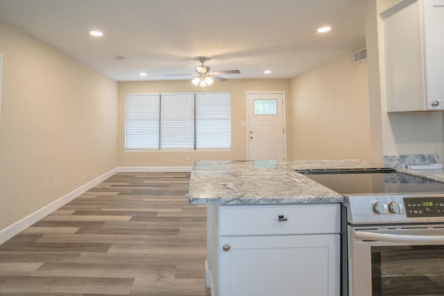 kitchen featuring stainless steel electric range oven, light stone countertops, ceiling fan, light hardwood / wood-style flooring, and white cabinets