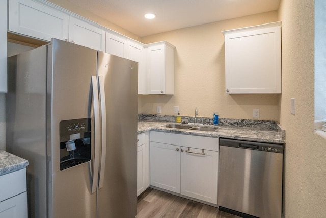 kitchen featuring white cabinetry, sink, and appliances with stainless steel finishes